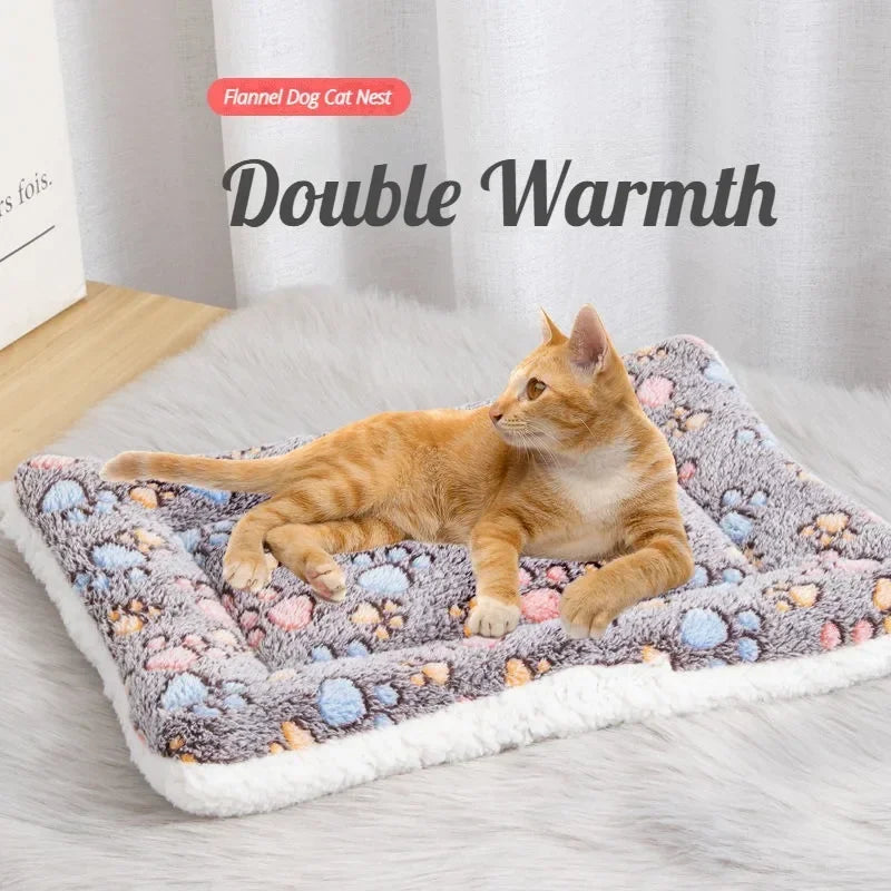 Cat lying comfortably on a double-sided pet mat with paw print pattern