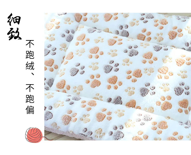 Close-up view of a double-sided pet mat showing paw print pattern and texture