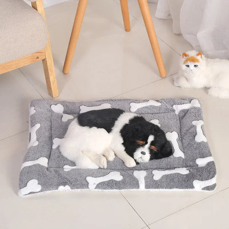 Gray double-sided pet mat with white bone patterns, with a dog comfortably sleeping on it and a cat nearby