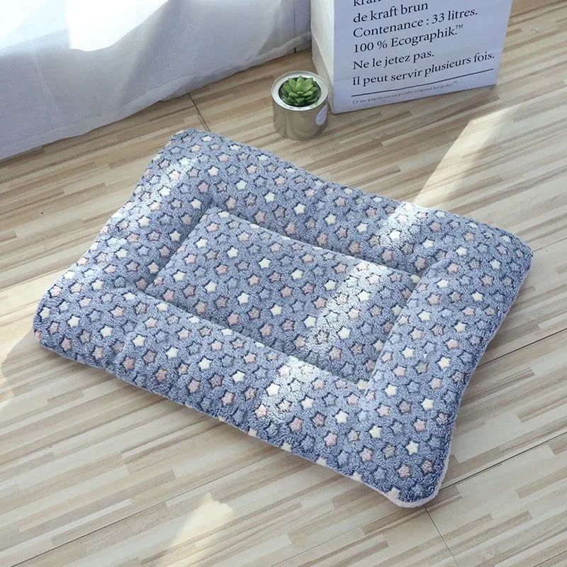 Gray double-sided pet mat with colorful star pattern displayed on a plain background