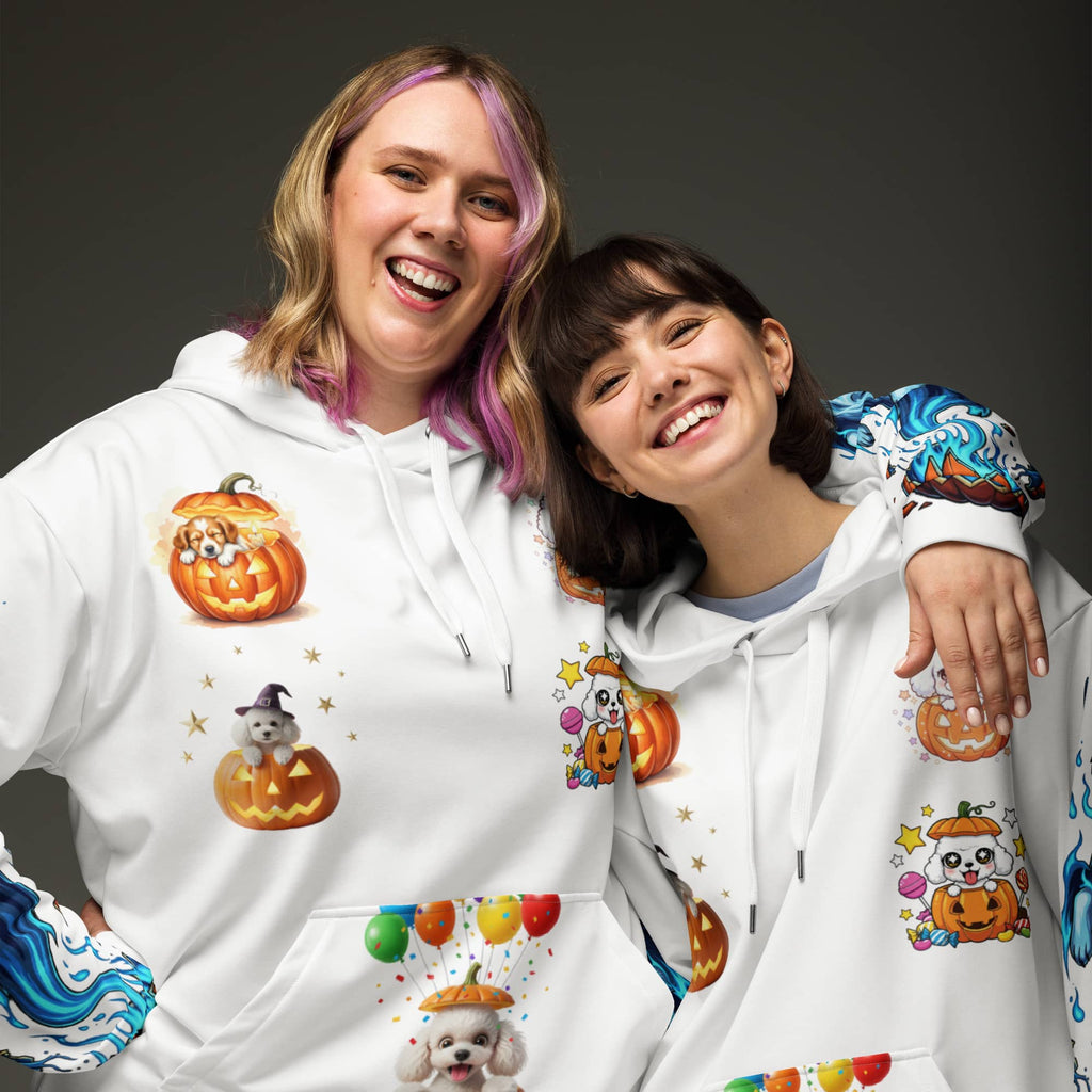 Two smiling women wearing matching white Halloween dog hoodies with pumpkin pups and blue husky flames