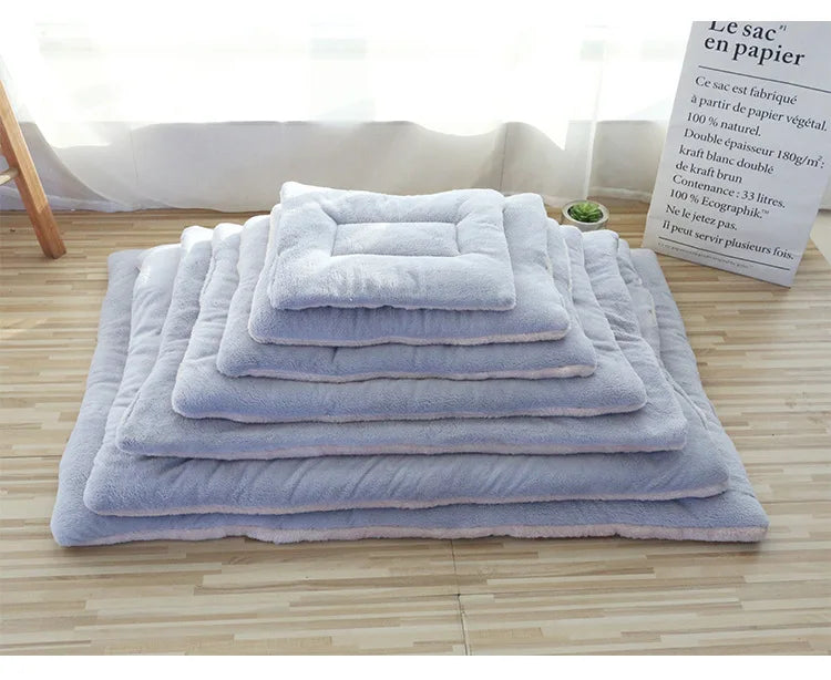 Light blue double-sided pet mats stacked together from smallest to largest size