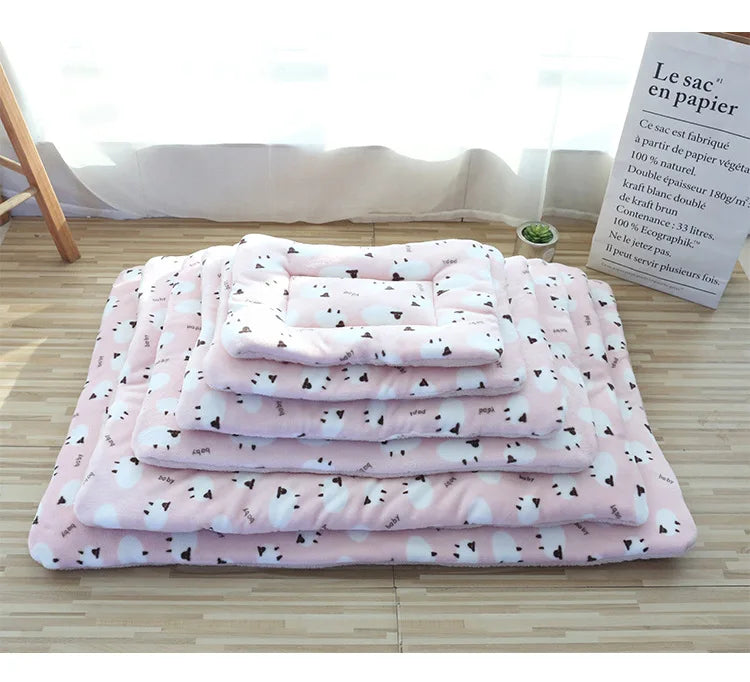 Light pink double-sided pet mats with black and white pet print arranged from smallest to largest size