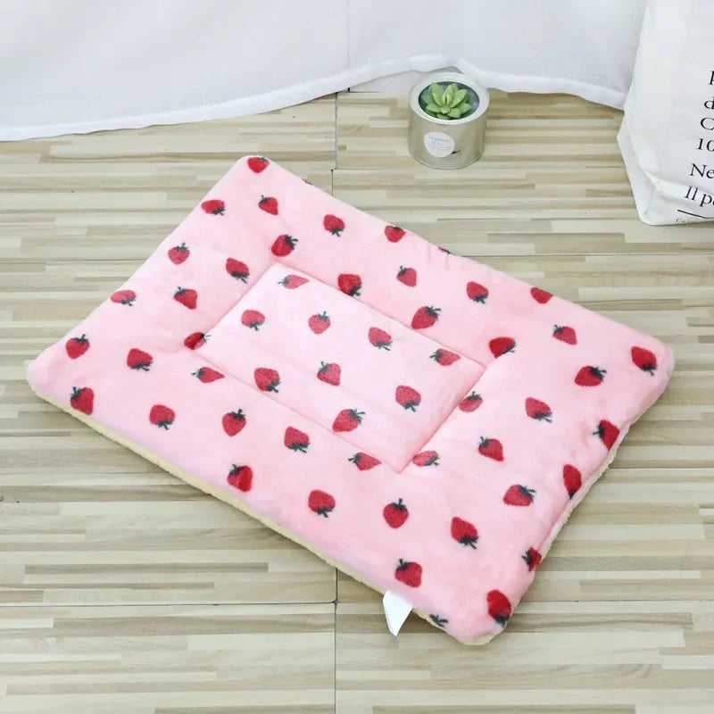 Pink double-sided pet mat with strawberry pattern displayed on a plain background